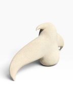 Side view of the "Bird" ceramic sculpture showcasing its sleek biomorphic silhouette and blue reactive glaze gradient.