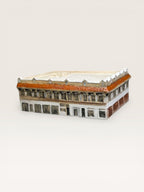Custom hand-painted ceramic architectural model of a historic commercial storefront building with terracotta trim.