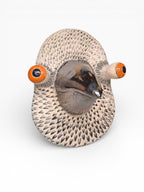 Artisan ceramic wall mask of a pigeon with detailed feather texture, made from Belgian Sibelco stoneware and German Terra Color glazes.