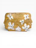 Large handmade ceramic wall sculpture showing two face profiles with white floral patterns, crafted from Belgian Sibelco stoneware, 38x20cm