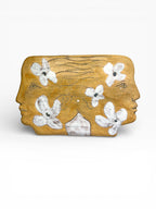 Large handmade ceramic wall sculpture showing two face profiles with white floral patterns, crafted from Belgian Sibelco stoneware, 38x20cm
