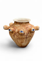 OK.CERAMICS handmade ceramic vase with rustic texture and surreal blue eye sculptures in a conceptual art style.