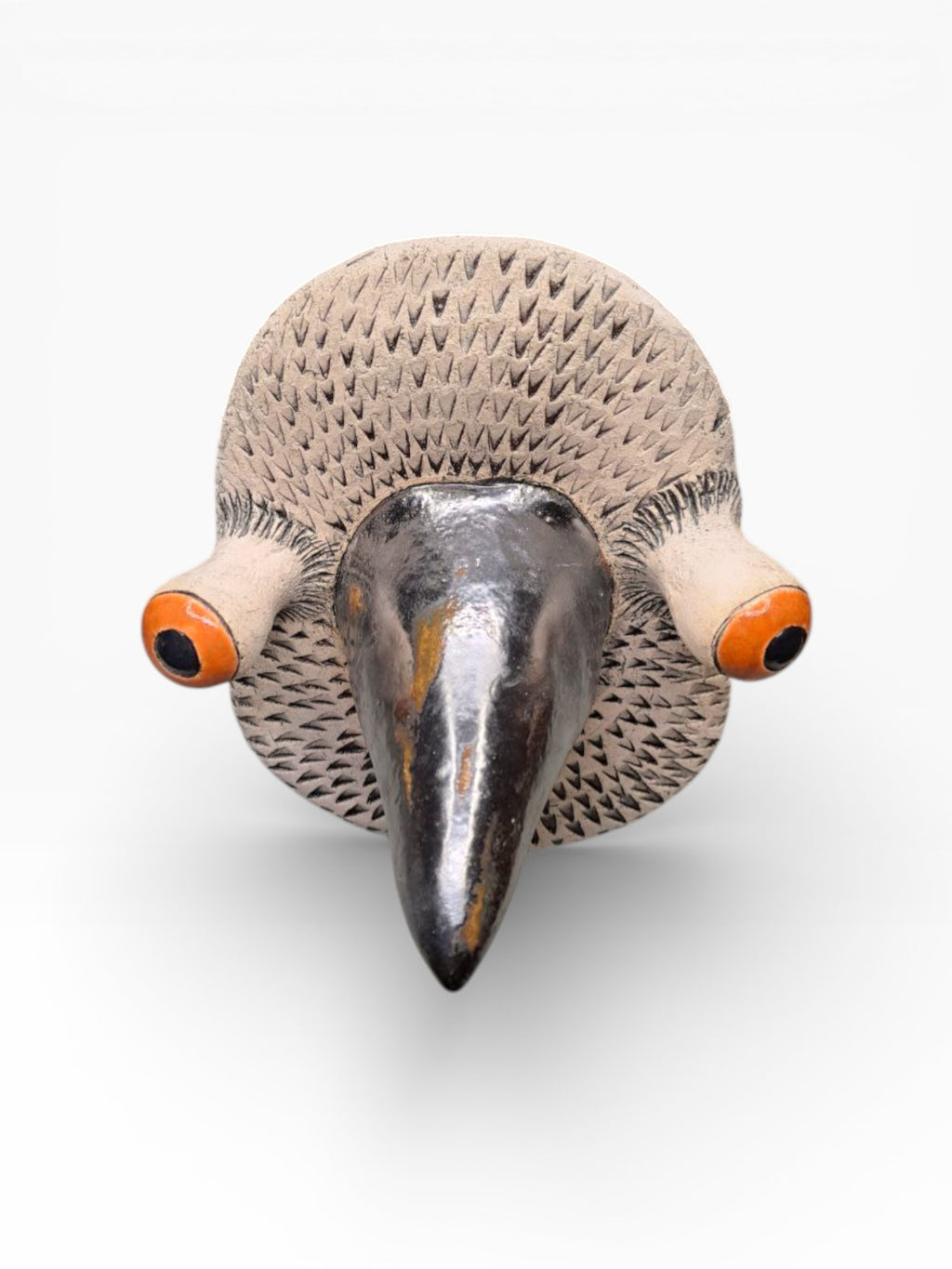 Close-up of a handmade ceramic bird mask showing expressive eyes and textured artisanal finish, size 20x15cm