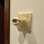 Detailed view of a unique ceramic green eye hook showing textured crackle finish and artisanal iris painting, 10x10cm.