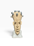 Front view of the "Thought Crown" surrealist ceramic bust featuring a craquelure glaze and dark blue spherical nodes.