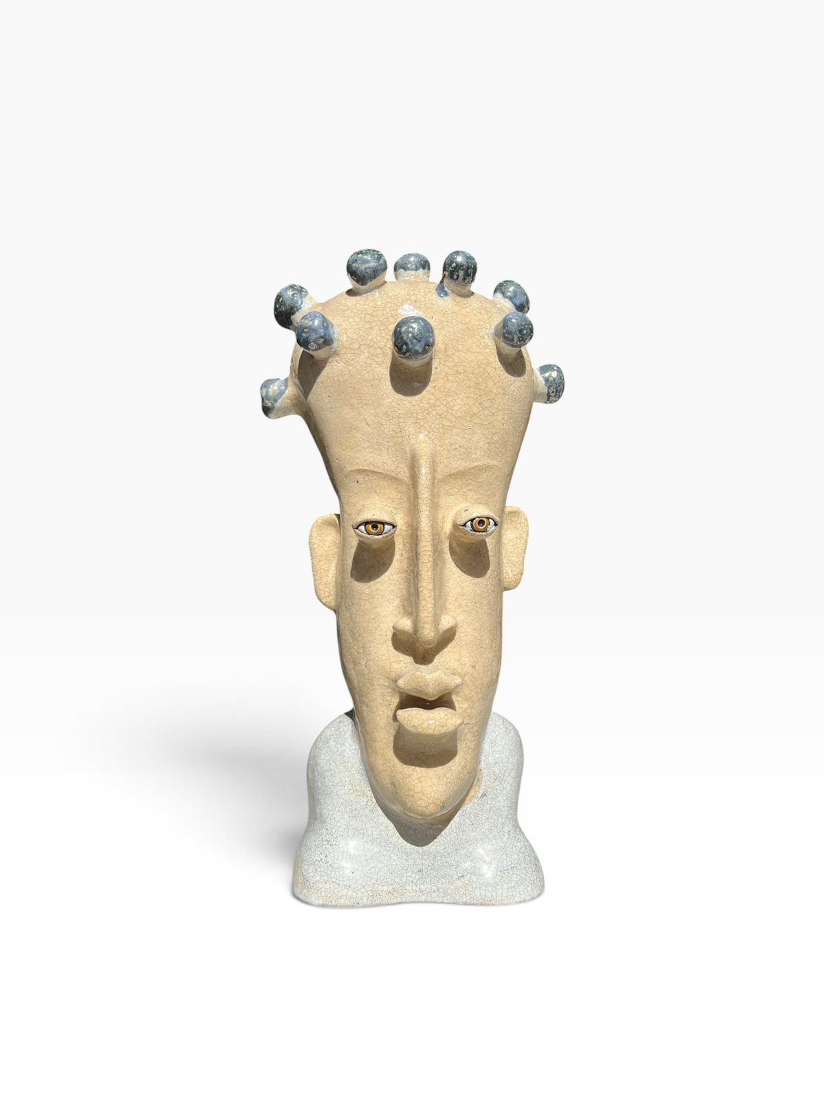 Front view of the "Thought Crown" surrealist ceramic bust featuring a craquelure glaze and dark blue spherical nodes.