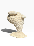 Side angle of the biomorphic "Volcano" sculpture showcasing its dynamic curved silhouette and matte stone texture.